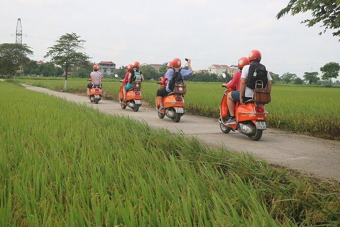 Beautiful Female Riders Vespa Red River Countryside Tour 5 Hours - A local family and market moment: the everyday layer