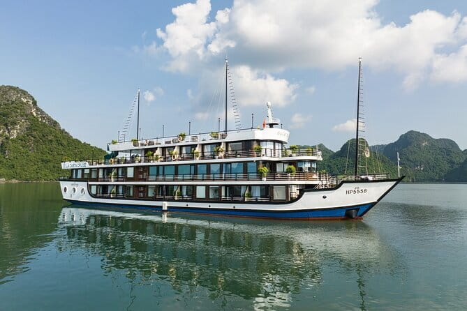 Le Theatre Cruise - Wonder on Ha Long & Lan Ha Bay 2 Days Tour - Day 2 at 6:15 AM: Tai Chi, sunrise light, and a cave stop