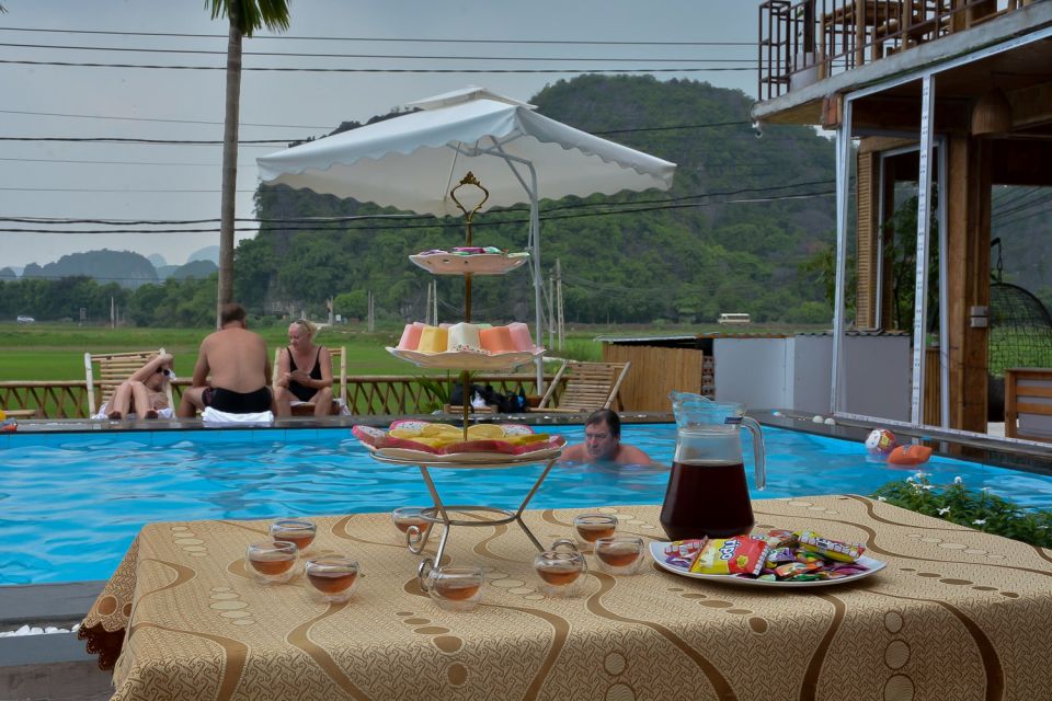 Ninh Binh Daily: Hoa Lu, Mua Cave, Tam Coc, Bike & Swimming - Sunset pool party: swim, tea, fruit, and a real payoff