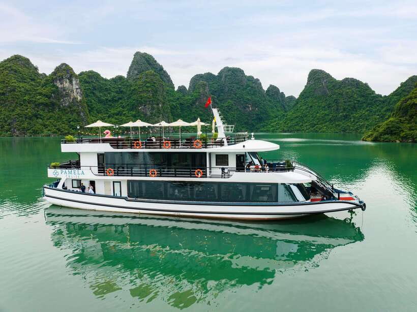 The BEST Ha Long Bay 5-Star Day Trip with Pamela Cruise - Boarding and the first real views: welcome drink and UNESCO vibes